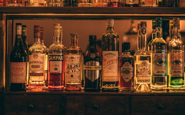 Behind bar liquor bottles at Doctor Inks Curiosities Exeter
