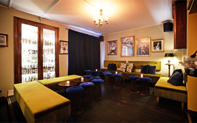 Curfew Copenhagen bar stylish blue stools and green sofas