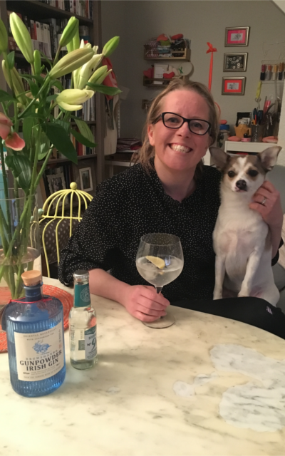 March cross word winner with g and t bouquet of lillies and jack russell dog on lap
