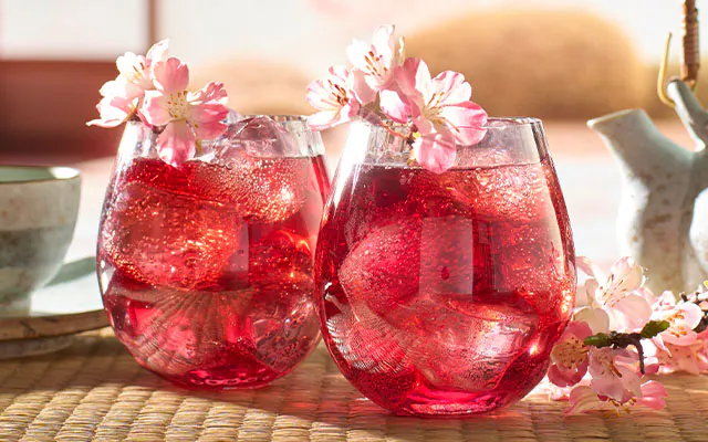 A delicious, red Wabi Sabi Sakura Gin cocktail with cherry blossom flowers 