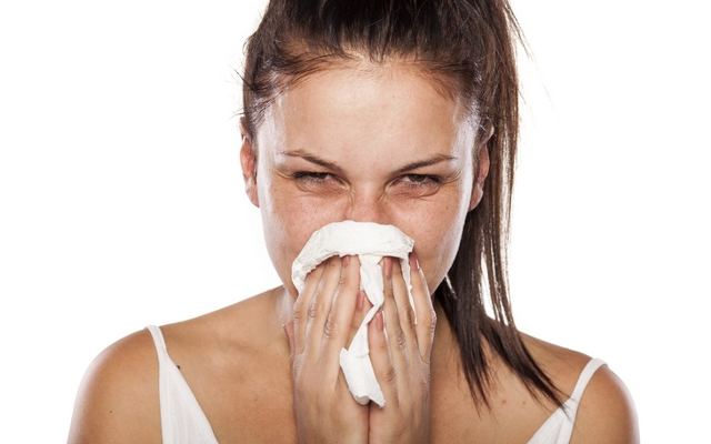 Woman blowing nose