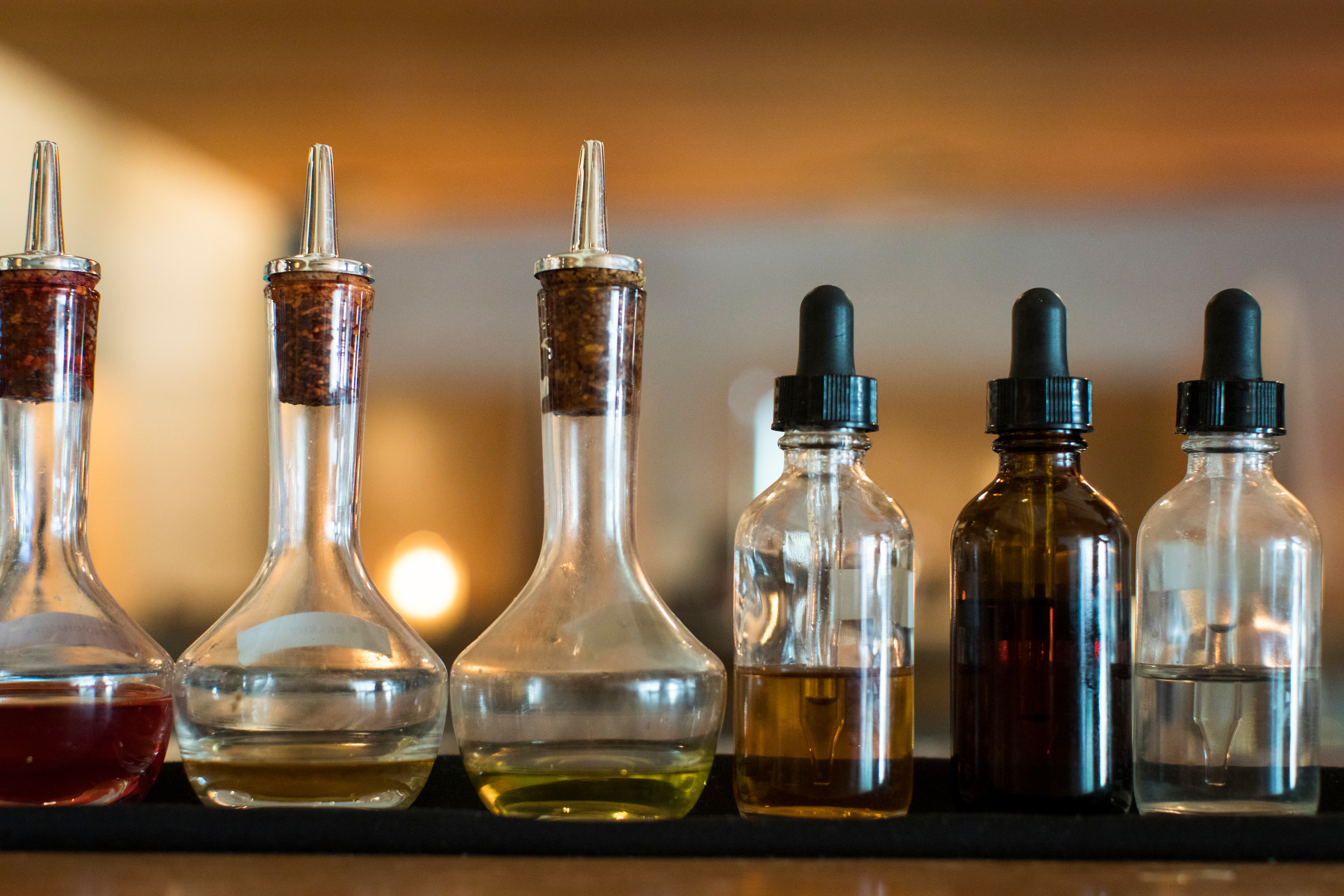 Small dropper bottles lined up on a counter