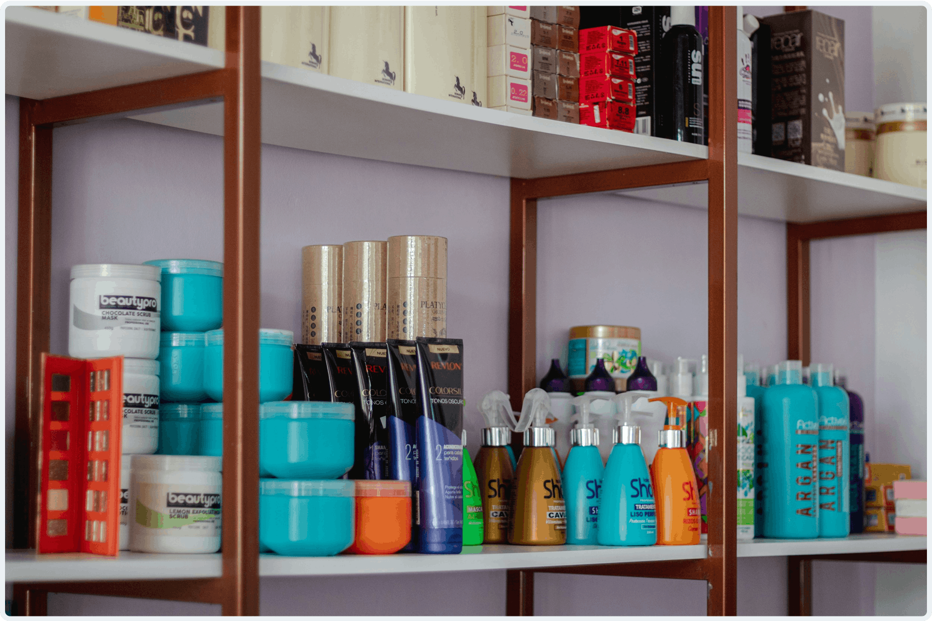 A shelf filled with different hair products