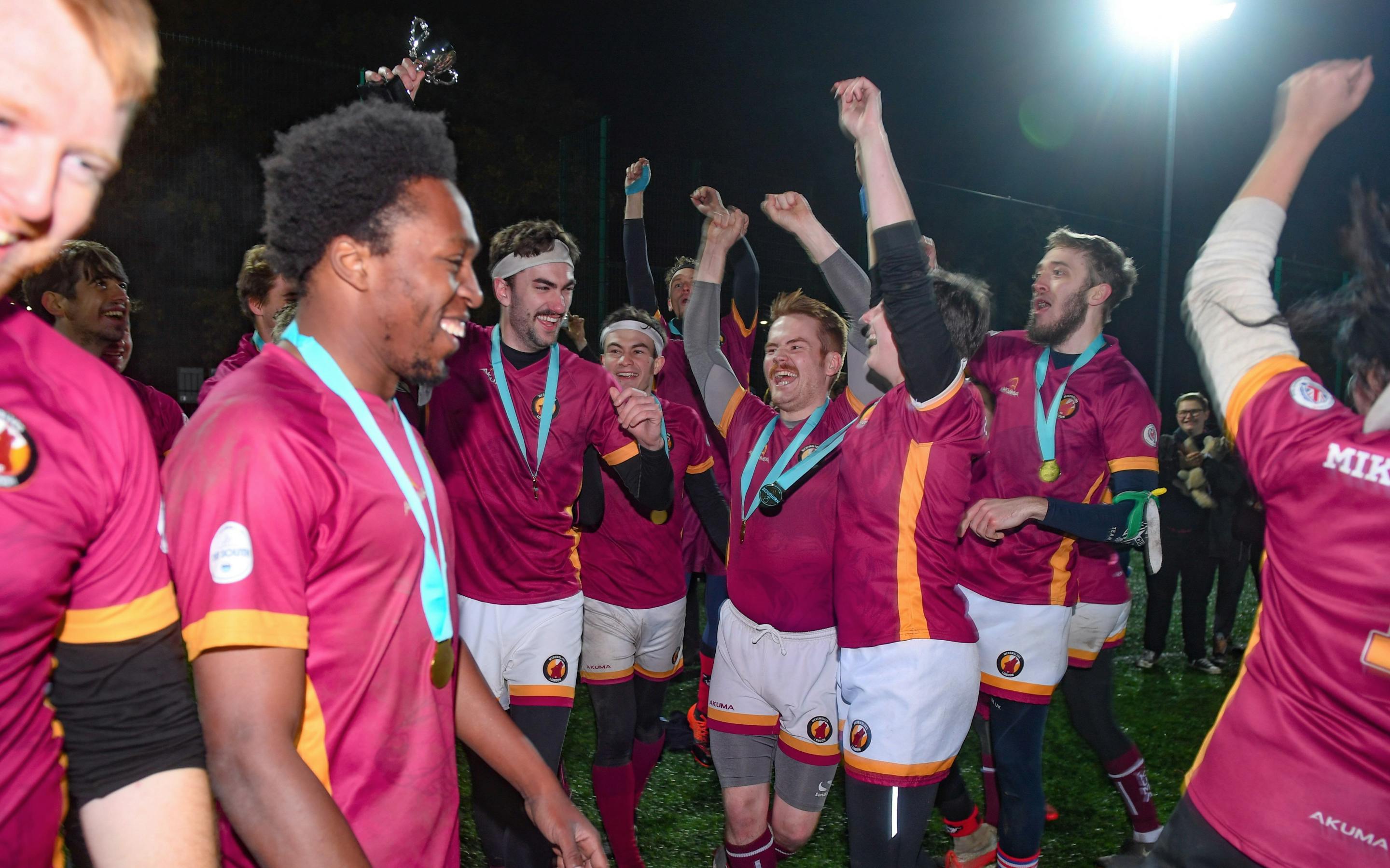 Werewolves of London celebrate their Southern Cup win with medals and trophy raised overhead