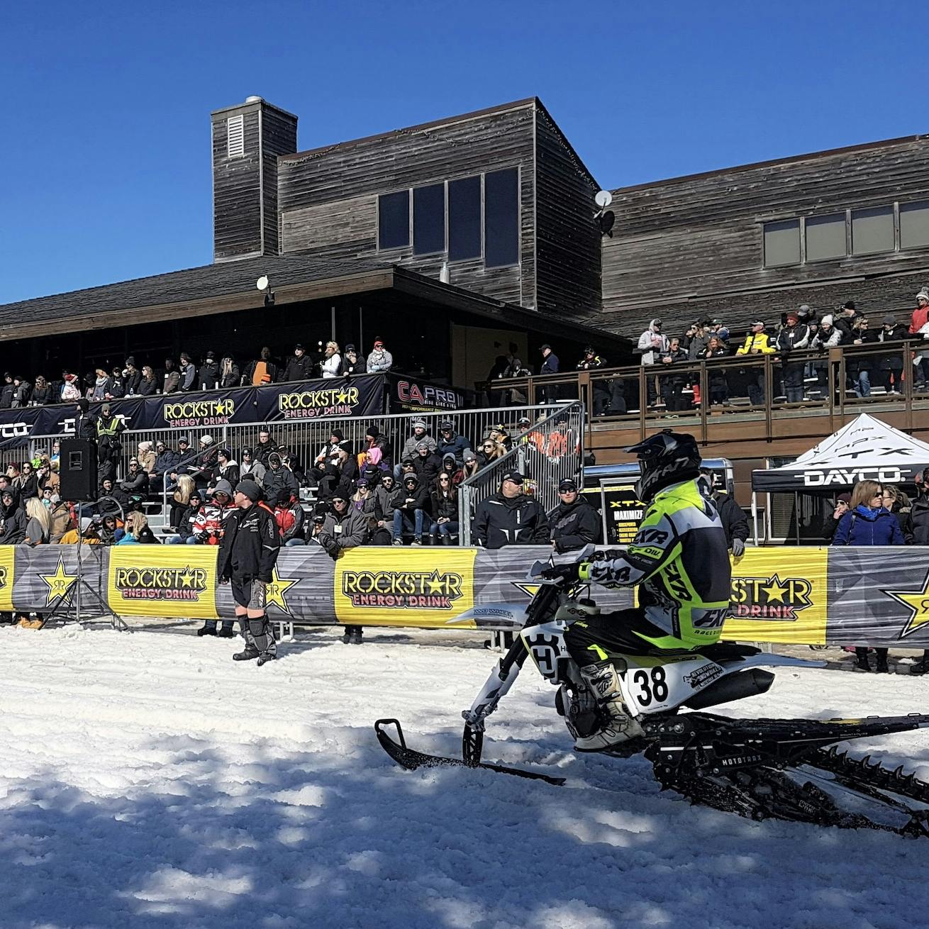 Snowmobile special events with a crowd watching a rider