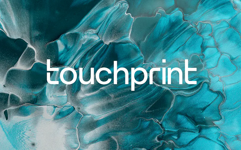 Touchprint logo in white over a textured background created by mixing blue and silver printer inks.