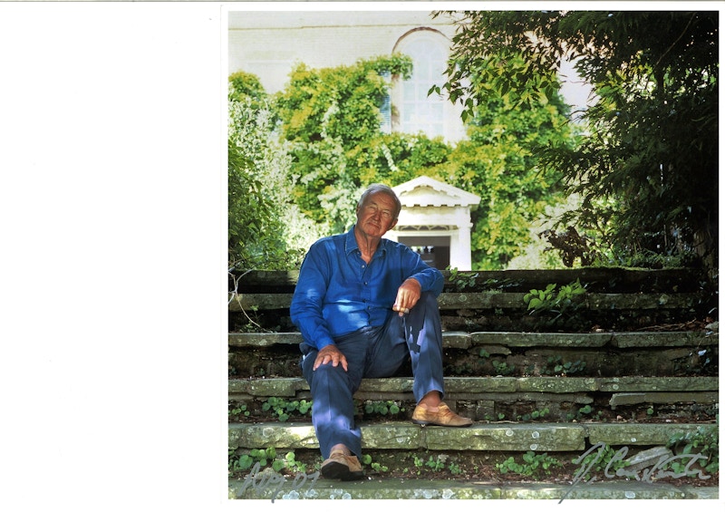 Terence Conran sitting on steps in his garden
