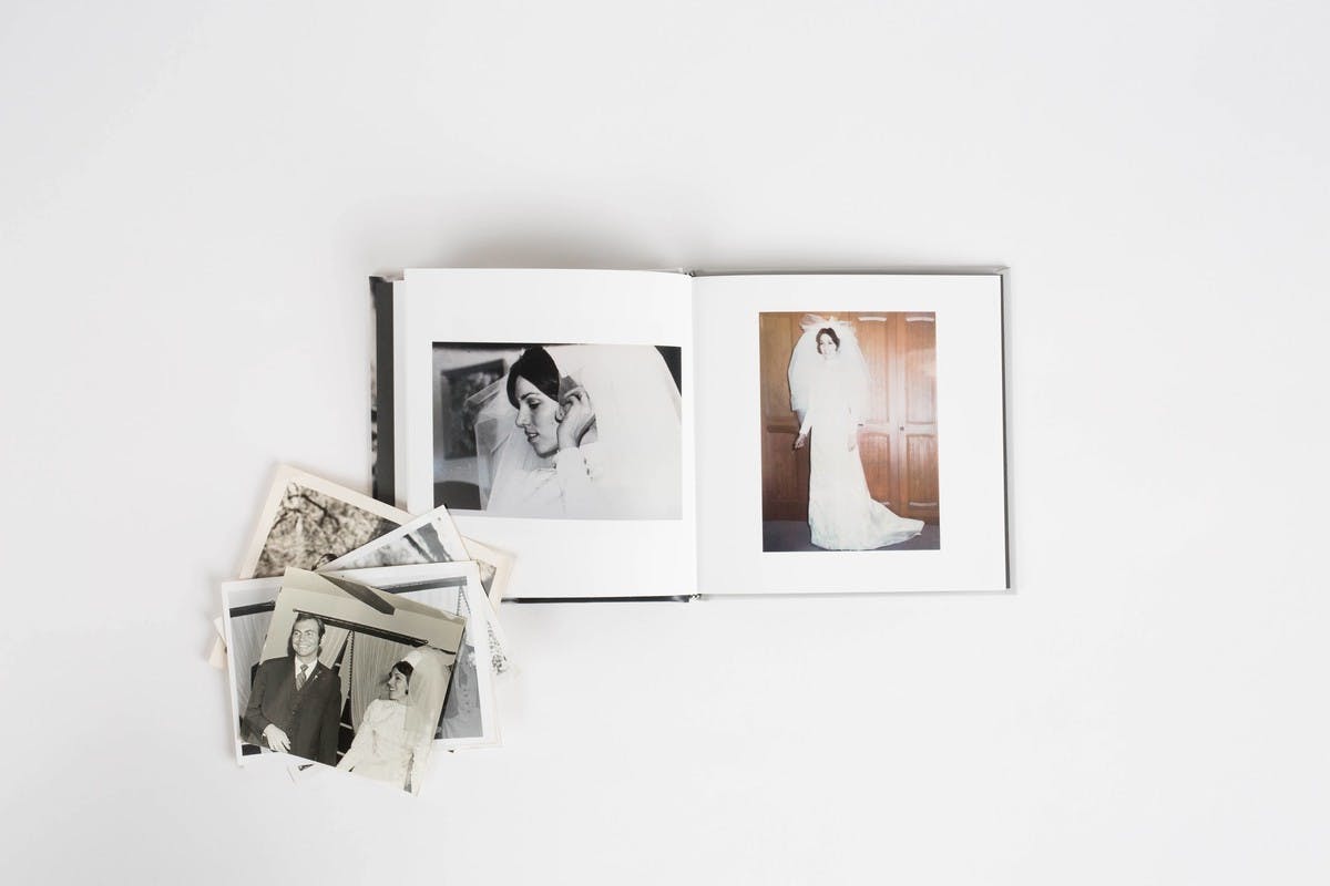 Chatbooks and old family photos on a white background