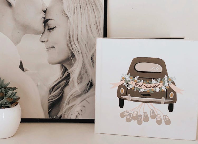 designer wedding photo book cover with open book showing bride and groom on wedding day