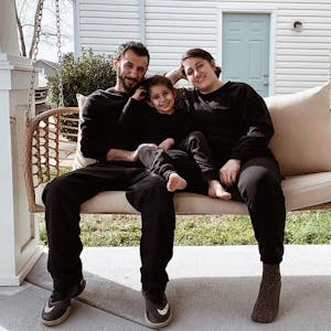 Family sitting on porch swing about to play a game