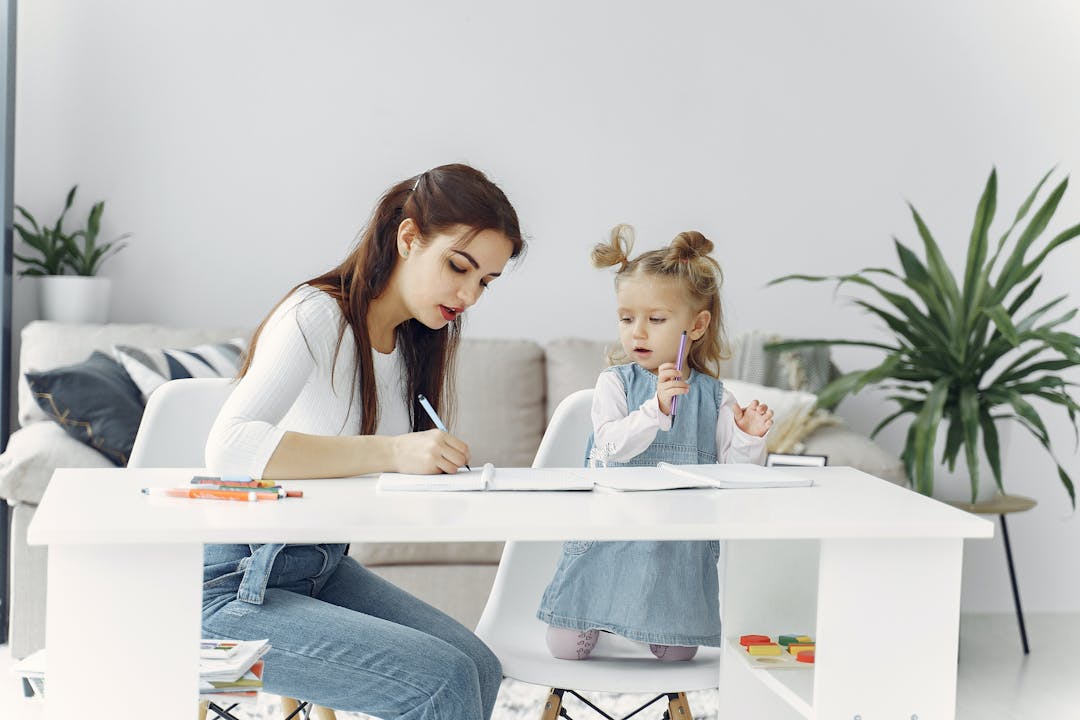 stressed mom with daughter writing down tips