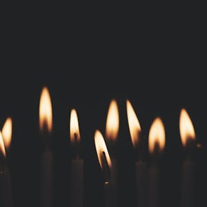 9 Candles are lit in a dark room for Hanukkah