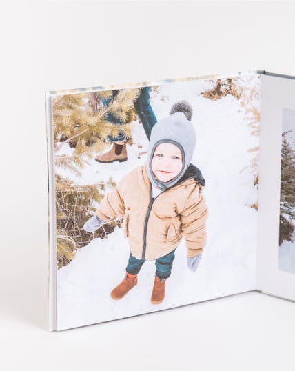 layflat photo album of little boy in snow