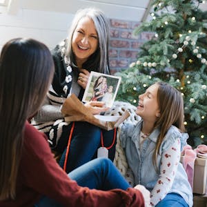 Grandmother shares a photo book with grandchildren