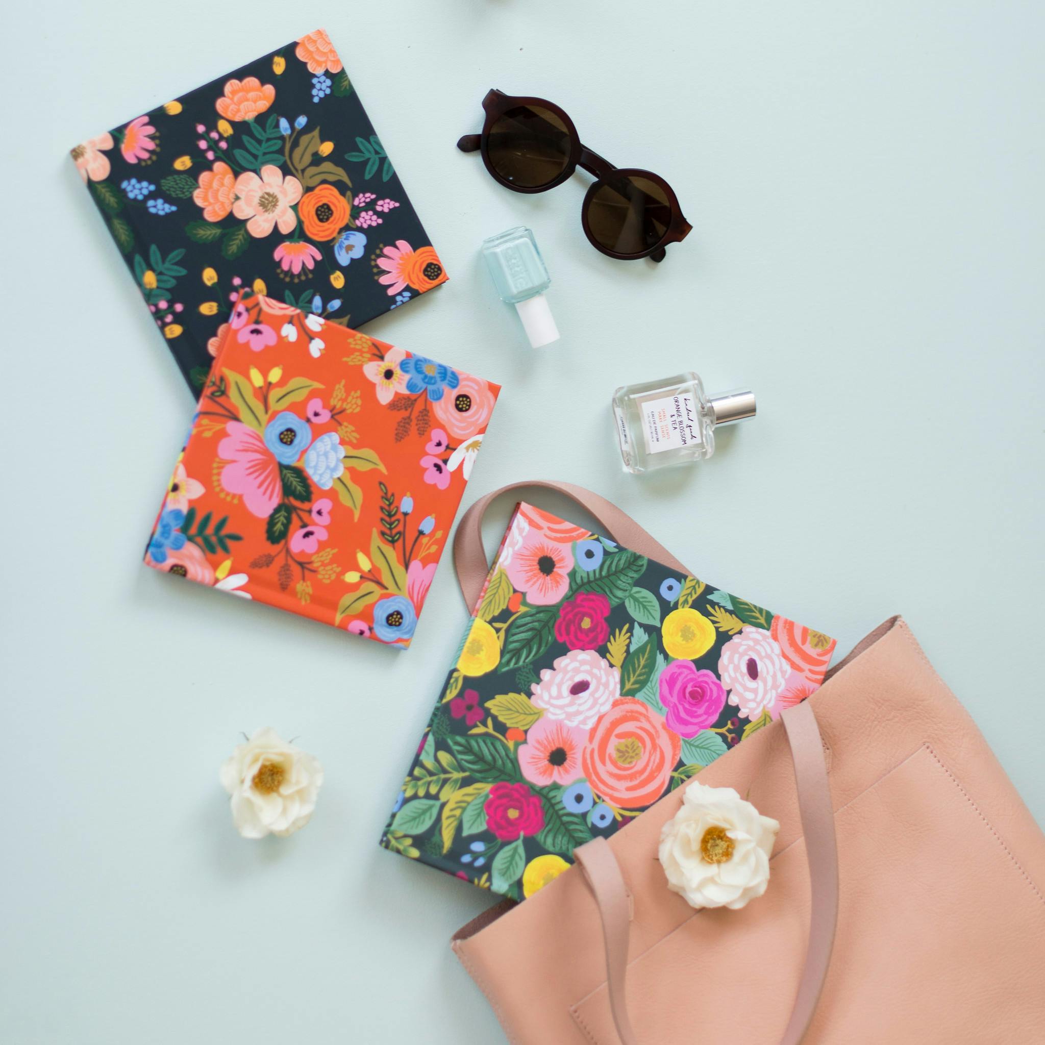 Rifle Paper Co Chatbooks covers coming out of a purse