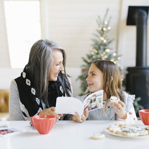 grandma reading a book to granddaughter