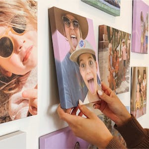 woman hands hanging up canvas prints