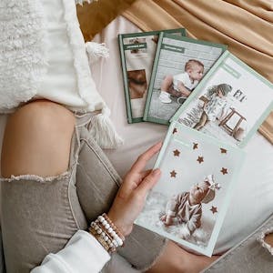 woman sitting with month books in bed