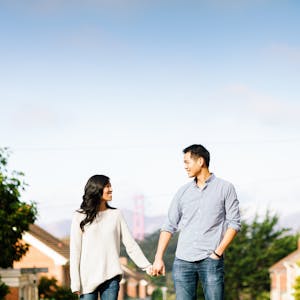 Couple holding hands in city