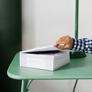 kids hand on stack on Instagram series Chatbooks