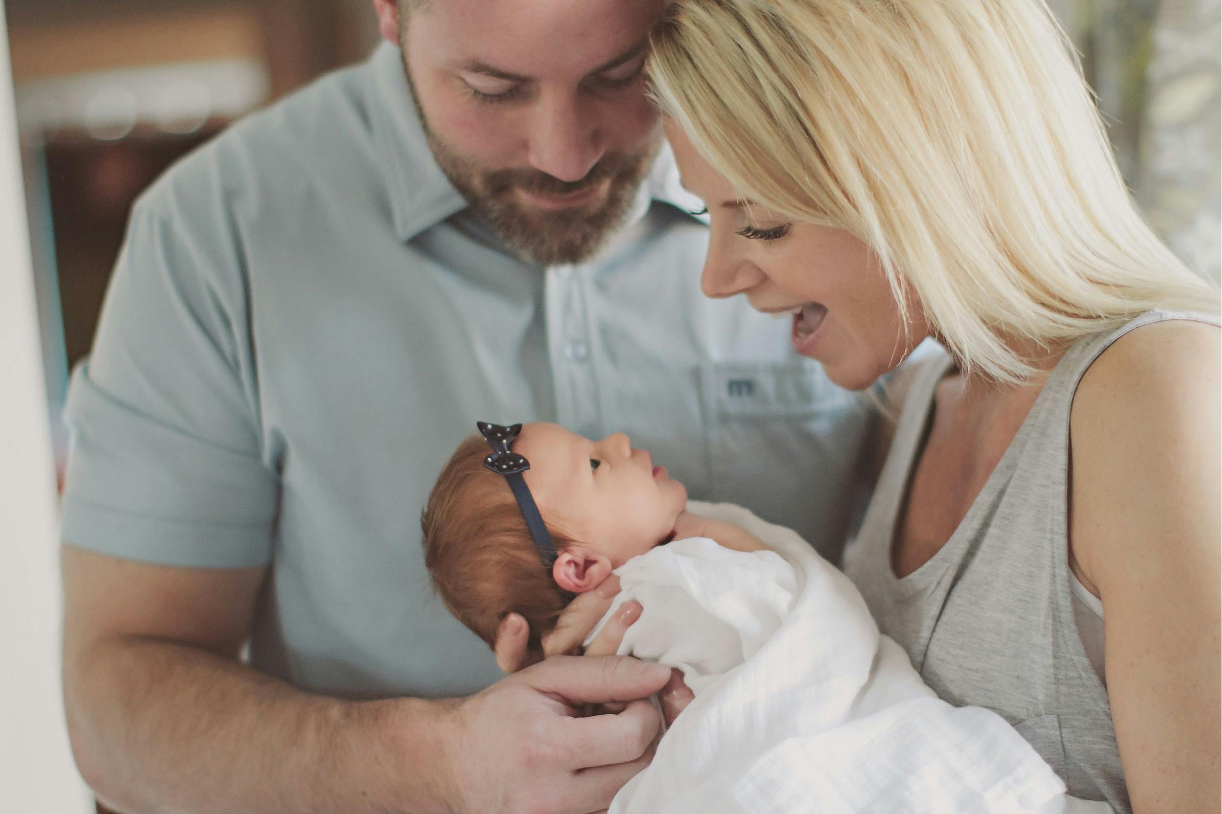 Mother and father holding a newborn