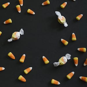 Candy corn and festive taffy displayed on a black backdrop