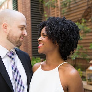 Couple poses for a photo of them looking into each other’s eyes