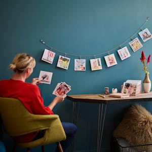 Woman at desk looking at Chatbooks photo prints