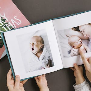 Mother and Baby look through a Christmas Chatbook full of baby photos