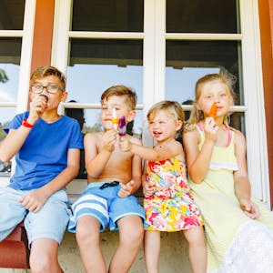 Children eating popsicles together