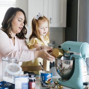 Mother and daughter baking together in the kitchen.