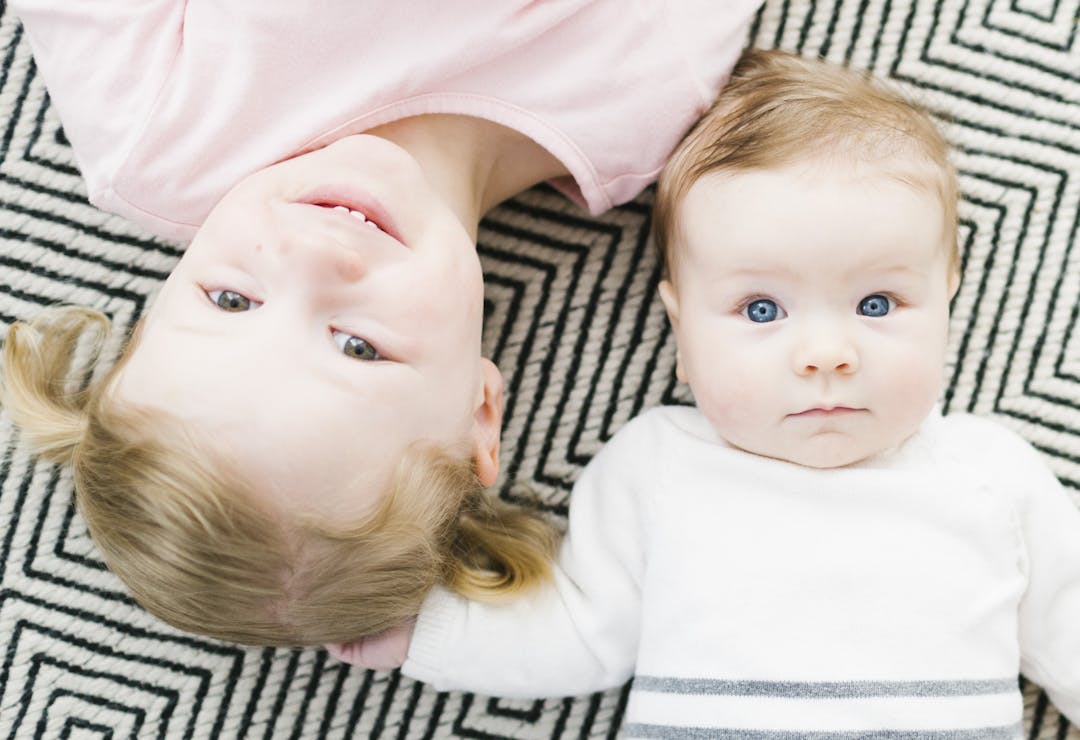 Picture of two kids smiling at the camera