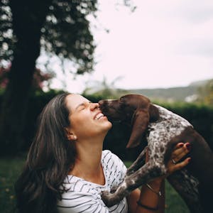 Dog and owner hugging