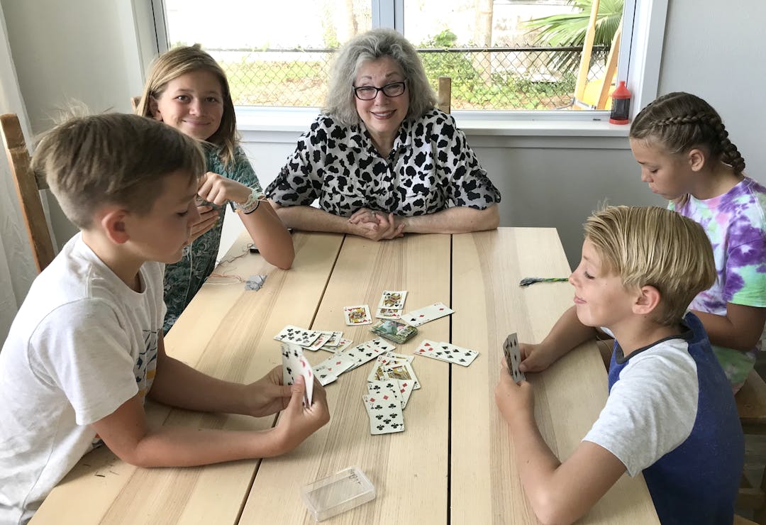Kids playing with family at table