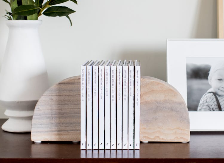 Instagram photo books on bookshelf between 2 bookends