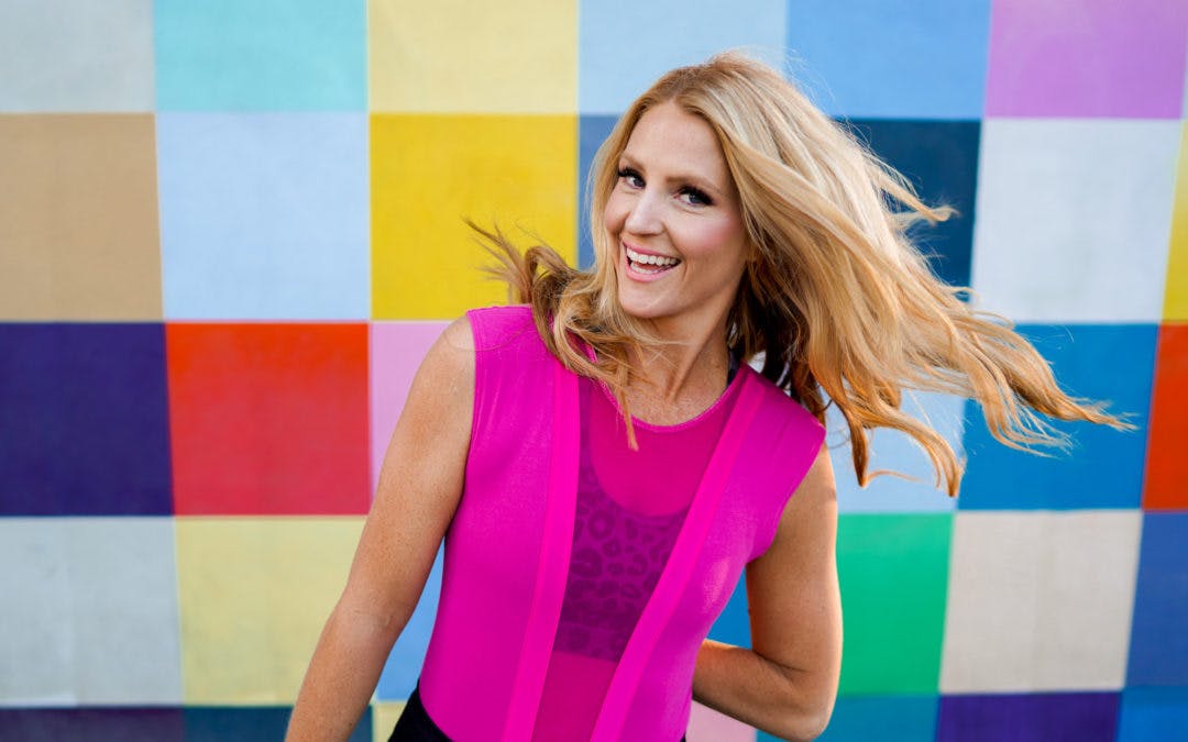 Emily Nelson of High Fitness in pink workout top