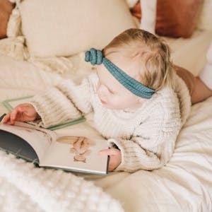 little girl looking at hardcover monthbook Chatbooks