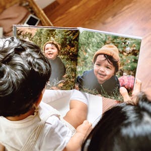baby looking at photo book