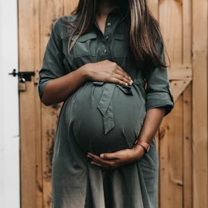 Pregnant mother hold her baby bump - Photo by Camylla Battani on Unsplash