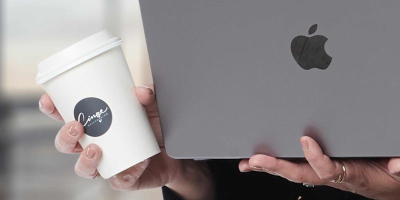 computer and coffee with cinqe coffee cup