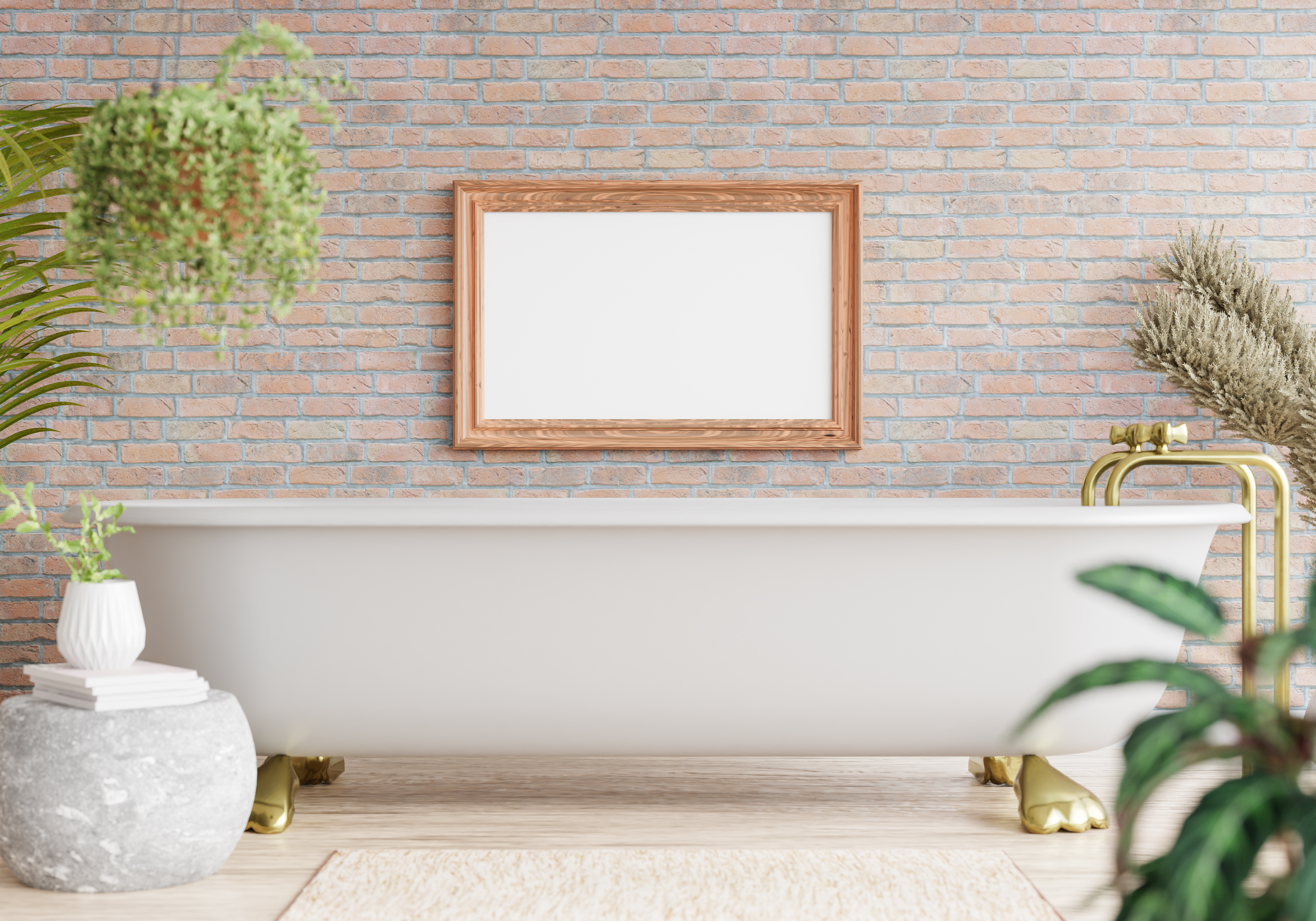 Bain blanc sur pieds en laiton dans une salle de bain avec des plantes et un mur en pierres.