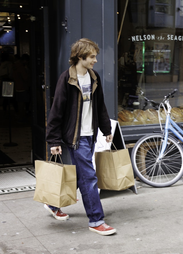 A resident leaving Nelson the Seagull with two large bags of food