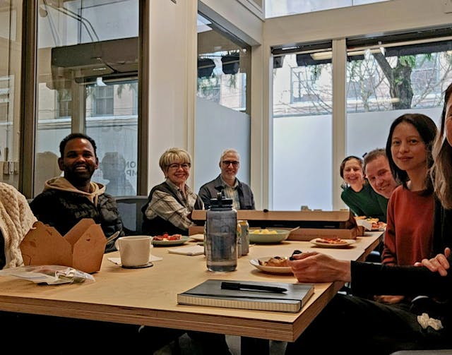 The CIRES team gathered around a table 