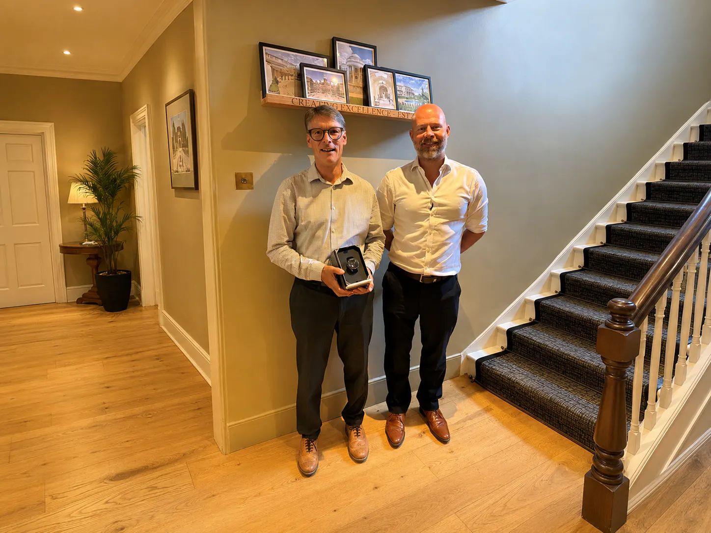 Two Men standing in front of a shelf