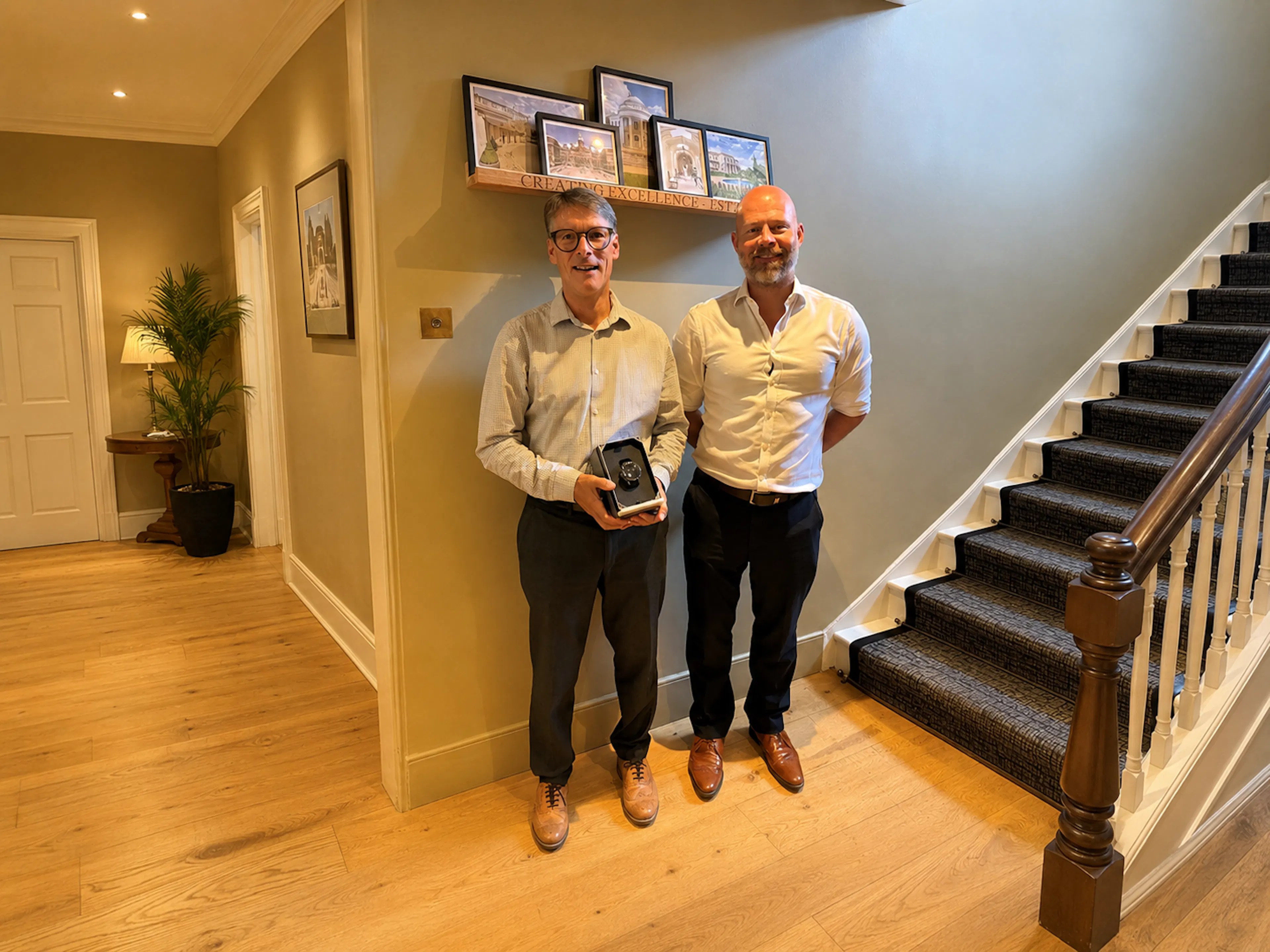 Two Men standing in front of a shelf