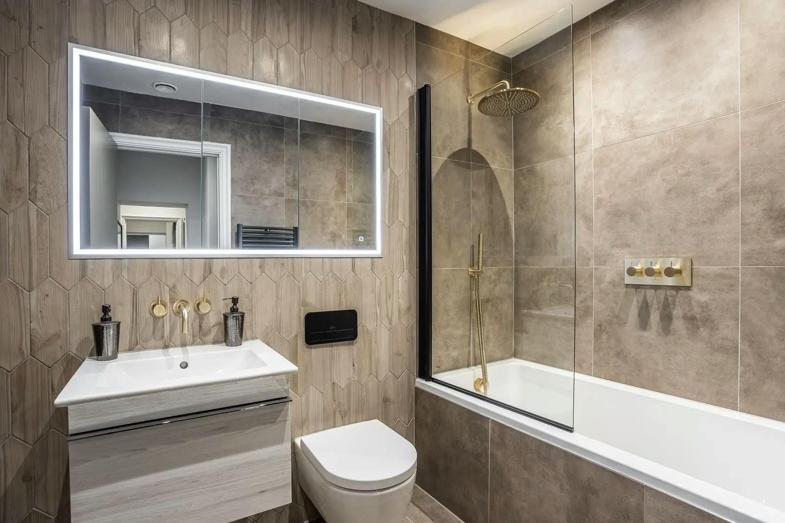 Caption: a bathroom with a sink, mirror, toilet and bathtub