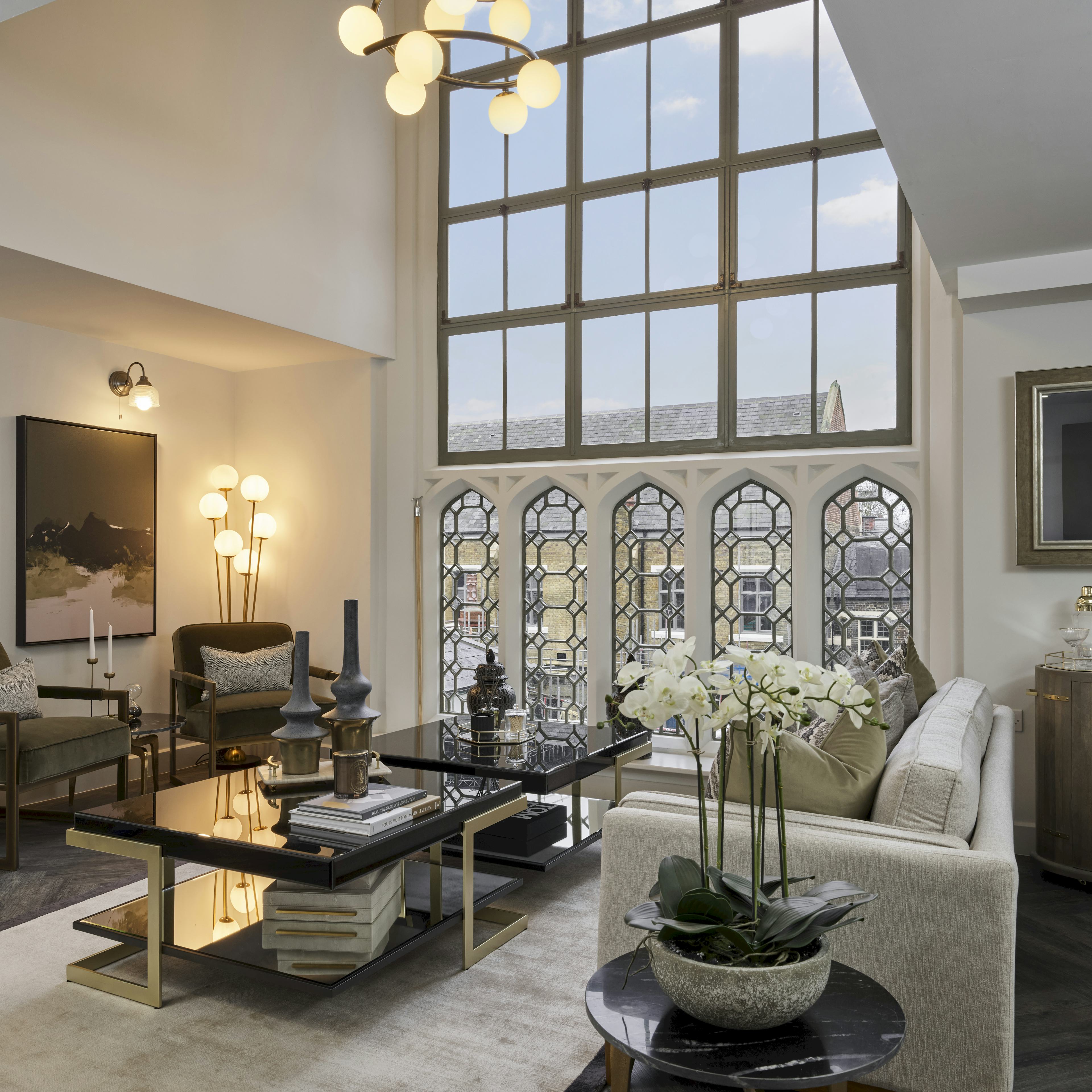 Caption: a living room filled with furniture and a large window