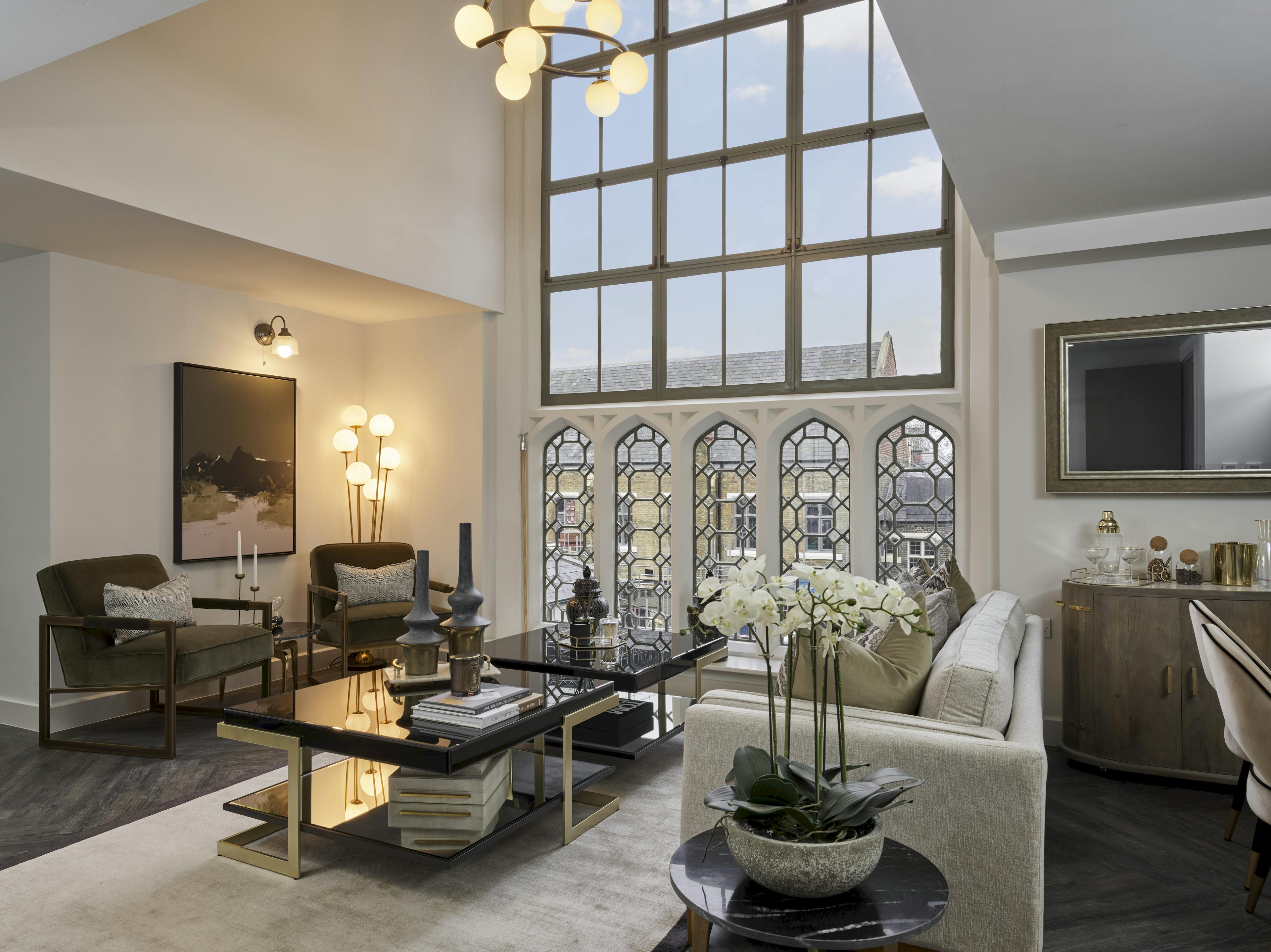 Caption: a living room filled with furniture and a large window