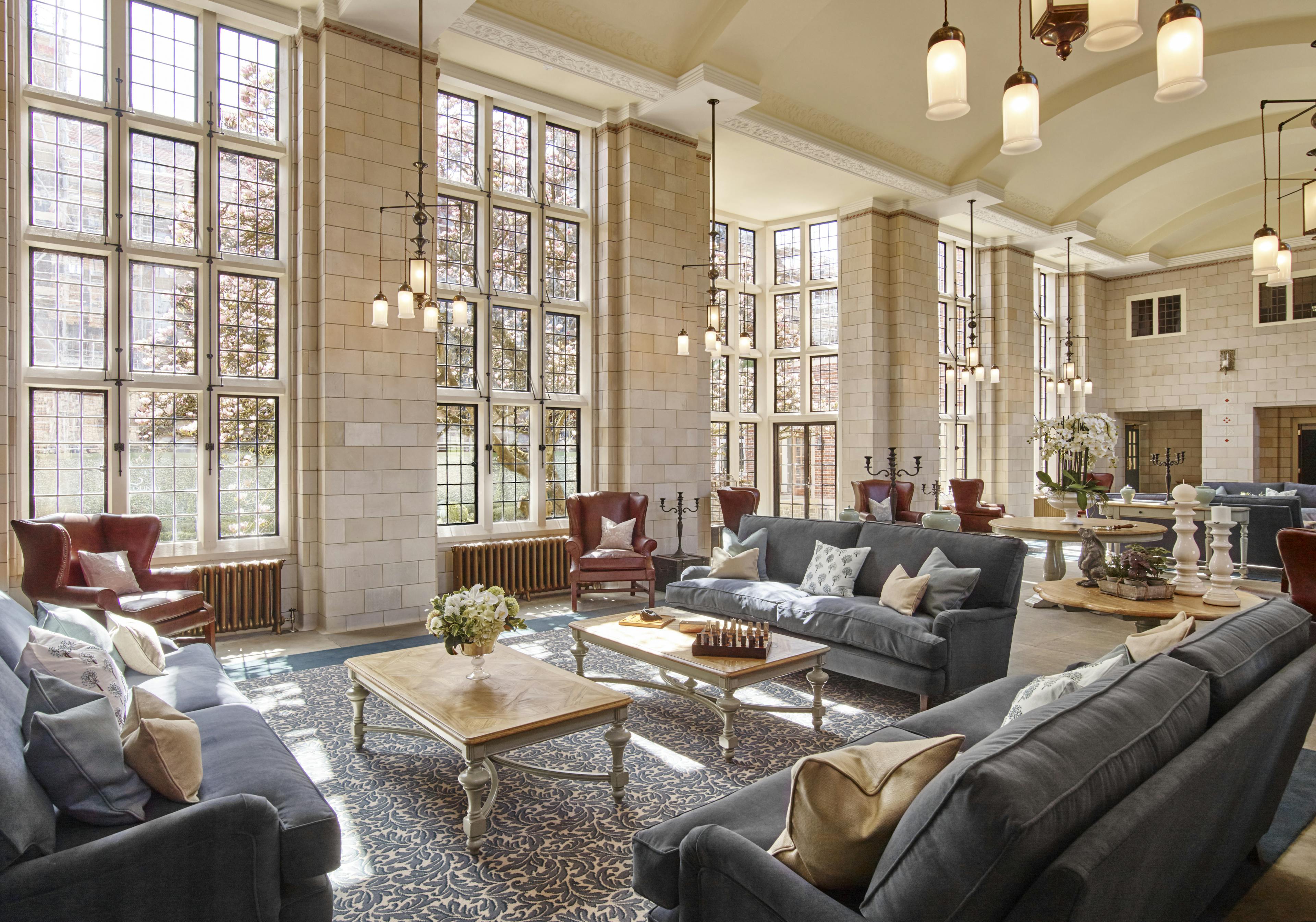 Caption: a living room filled with furniture and windows