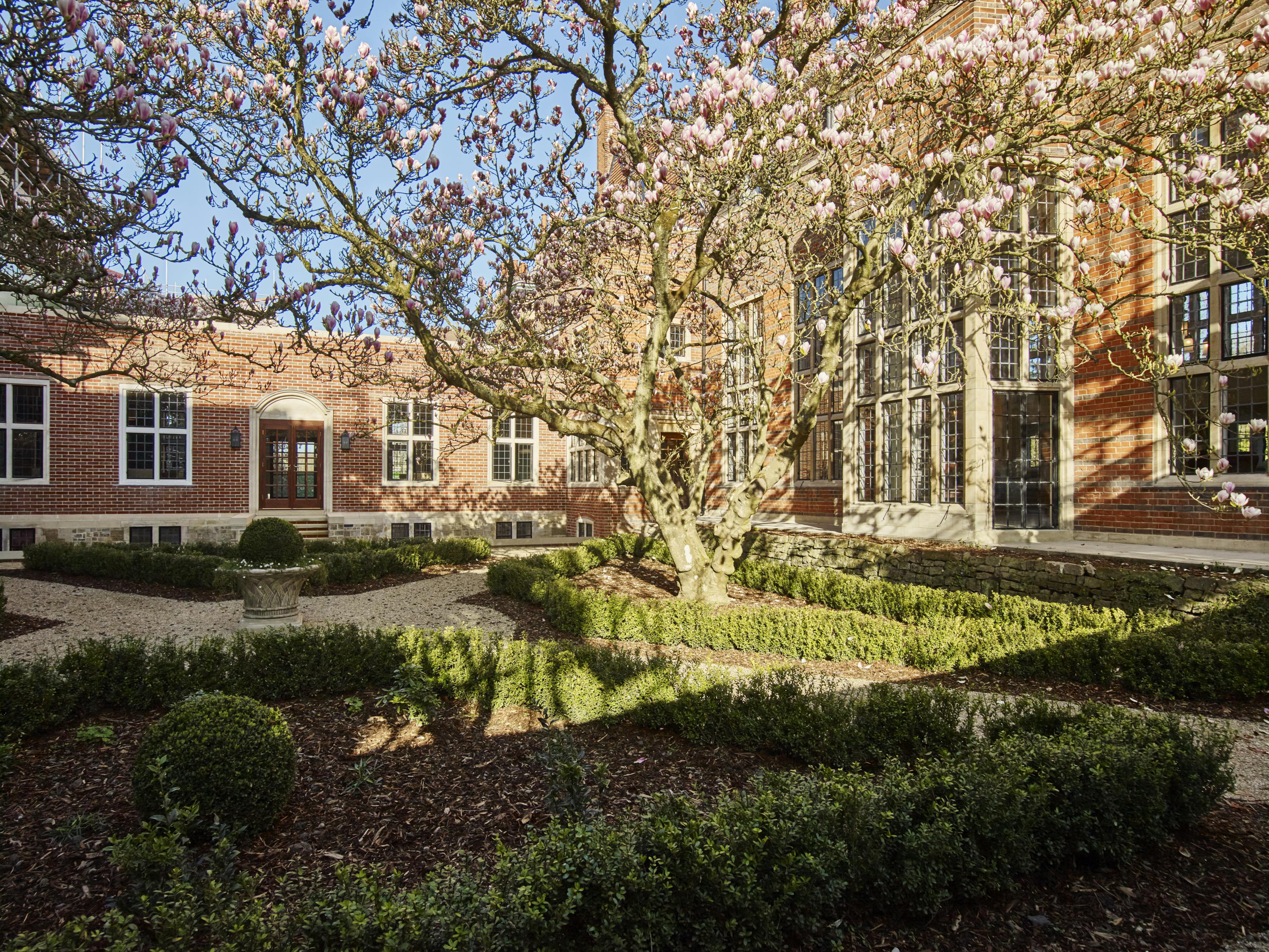 Caption: a building with a tree in front of it
